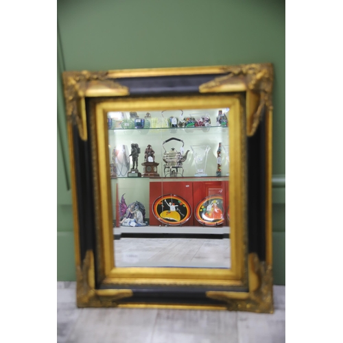 951 - Large Rectangular ornate mirror with Black and Gilt frame with Bevelled Glass.. Measures approx 24 x... 