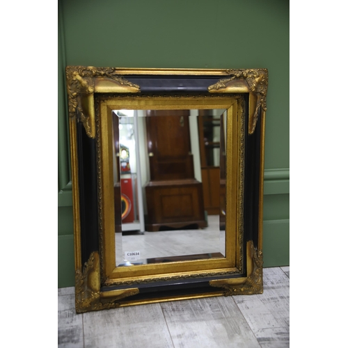 951 - Large Rectangular ornate mirror with Black and Gilt frame with Bevelled Glass.. Measures approx 24 x... 