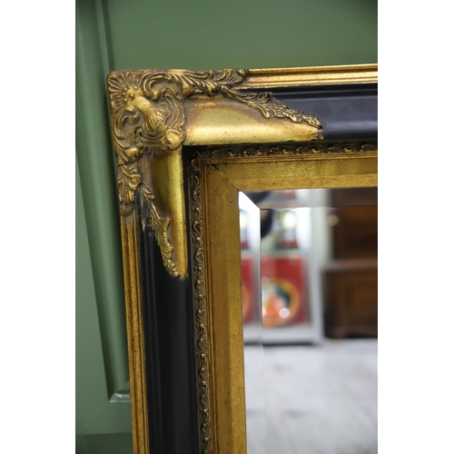 951 - Large Rectangular ornate mirror with Black and Gilt frame with Bevelled Glass.. Measures approx 24 x... 