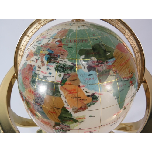 554 - World globe in brass gimbal with compass and set with semi precious stones, 14.5