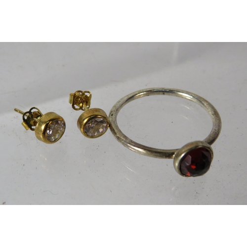 389 - Pair 9ct Cz set stud earrings and a 925 silver pandora ring set with a garnet.