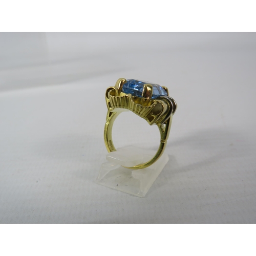 390 - 18ct Gold Statement ring set with a blue topaz 16mm by 10mm, finger size O. 15.7 grams