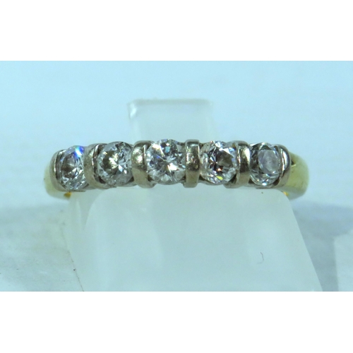 391 - 18ct Gold ring set with five 3mm diamonds, finger size M, 3.3 grams.