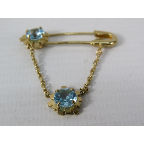 392 - 9ct Yellow Gold Safety Pin styled brooch set with two 6mm Topaz.  Total Weight 4.4g