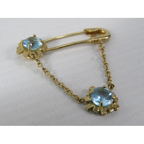 392 - 9ct Yellow Gold Safety Pin styled brooch set with two 6mm Topaz.  Total Weight 4.4g