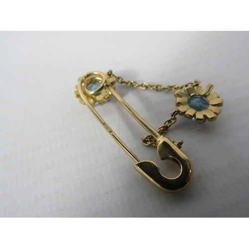 392 - 9ct Yellow Gold Safety Pin styled brooch set with two 6mm Topaz.  Total Weight 4.4g