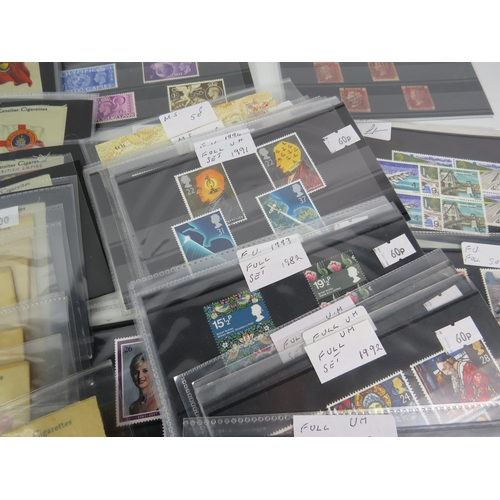 593 - Over 100 set of mainly mint stamps sets &  a large selection of unused postcards and Kensitas Cigare... 