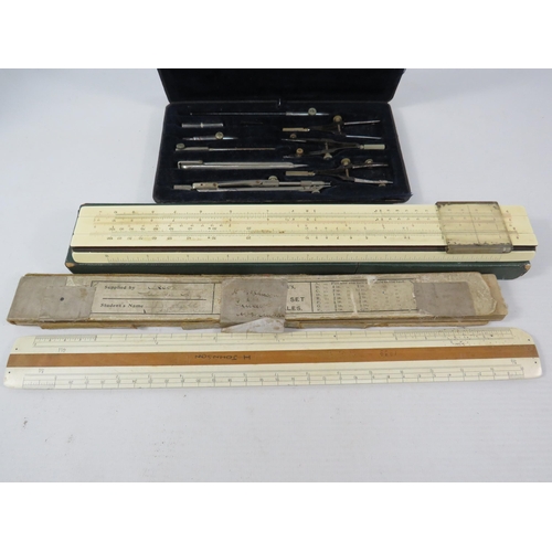 612 - A vintage technical drawing set and slide rules.