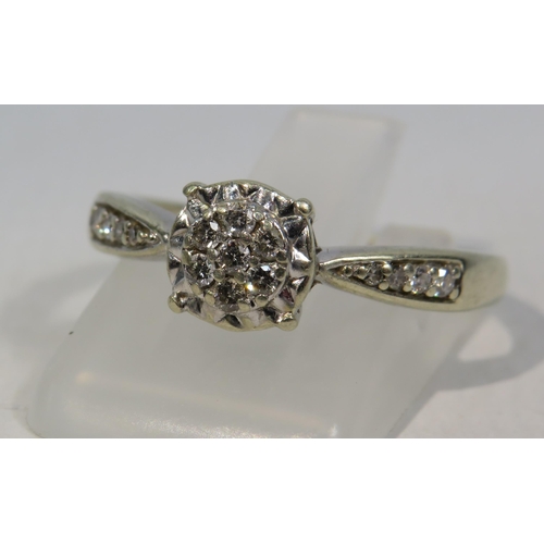 270a - 9ct White Gold Diamond ring, Seven central diamonds & four to each shoulder .15ct, size R. 2.6 grams