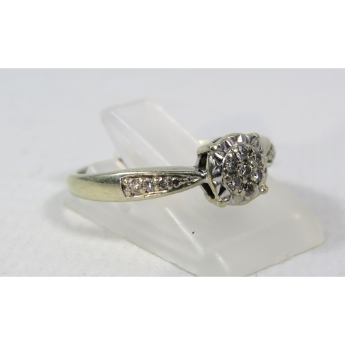 270a - 9ct White Gold Diamond ring, Seven central diamonds & four to each shoulder .15ct, size R. 2.6 grams