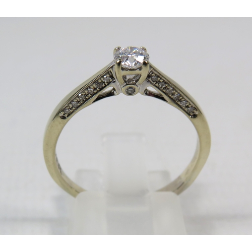 284a - 18ct White gold .40ct diamond solitaire ring with Accents to the inner shoulders, finger size R. 3.3... 