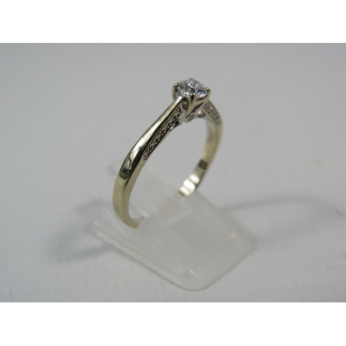 284a - 18ct White gold .40ct diamond solitaire ring with Accents to the inner shoulders, finger size R. 3.3... 