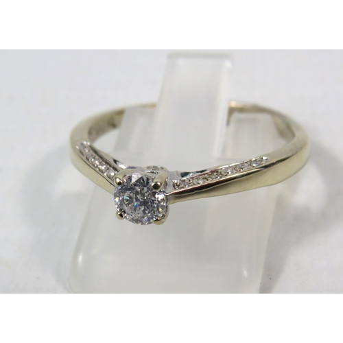 284a - 18ct White gold .40ct diamond solitaire ring with Accents to the inner shoulders, finger size R. 3.3... 