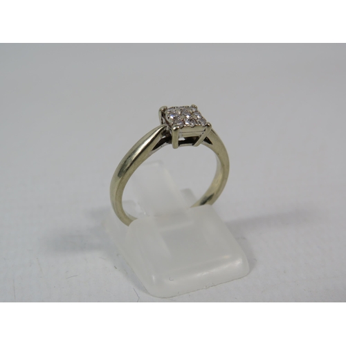 286a - 18ct White gold ring set with nine diamonds in a square, .13 ct, finger size K. 3 grams.