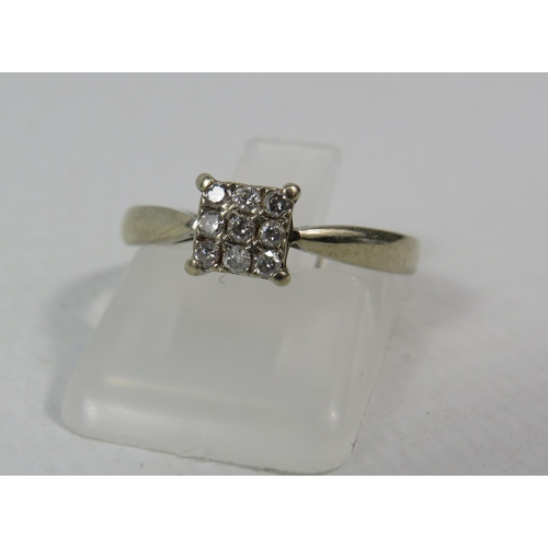 286a - 18ct White gold ring set with nine diamonds in a square, .13 ct, finger size K. 3 grams.