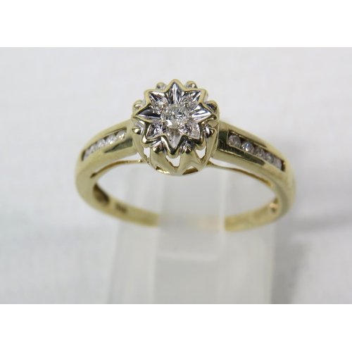 287a - 9ct Yellow gold 15pt diamond ring, Central diamond set within a star illusion and Five diamonds to e... 