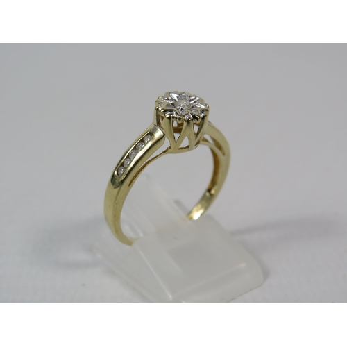 287a - 9ct Yellow gold 15pt diamond ring, Central diamond set within a star illusion and Five diamonds to e... 