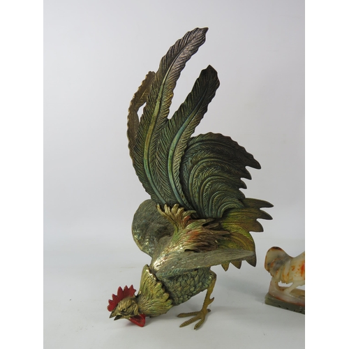 681 - Brass painted metal fighting cockerel plus a small onyx cockerel. The largest stands 10.5