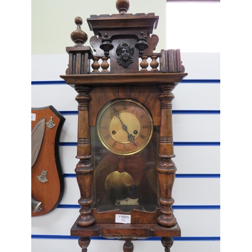 773 - Twin train chiming oak cased wall clock with key and pendulum in working order Measures approx 28 in... 