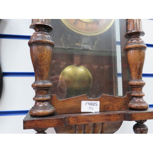 773 - Twin train chiming oak cased wall clock with key and pendulum in working order Measures approx 28 in... 