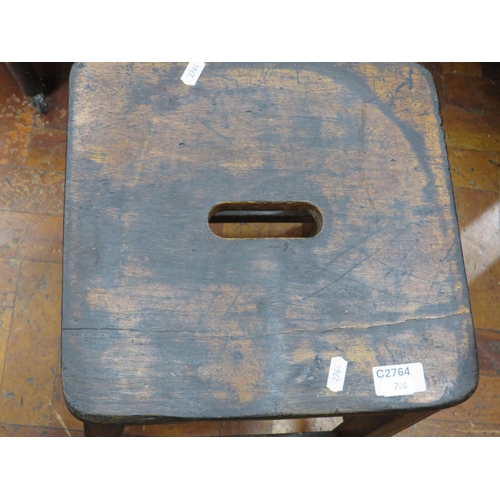 780 - Victorian Four legged Stool with hand hole to shaped seat. In very good condition. Measures 24 inche... 