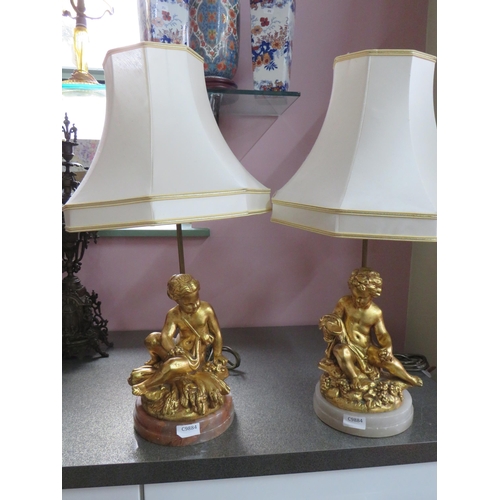 782 - Pair of Gold Painted Spelter Lamp bases featuring Cherub bodies,  Brass light column.  Each raised o... 