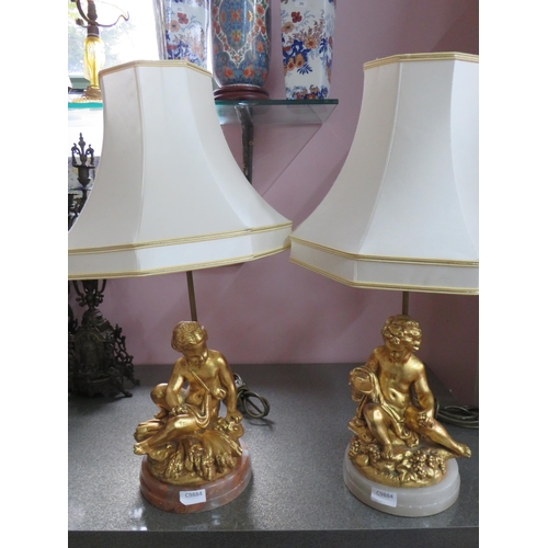 782 - Pair of Gold Painted Spelter Lamp bases featuring Cherub bodies,  Brass light column.  Each raised o... 