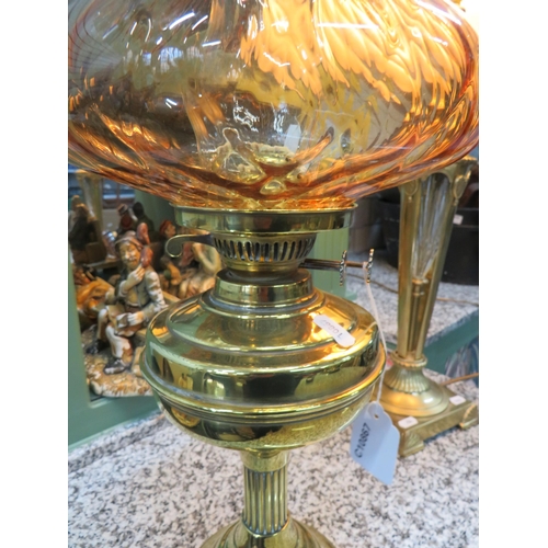 785 - Lovely Brass and Glass Oil lamp with short corinthian column base with brass reservoir. Lovely Amber... 