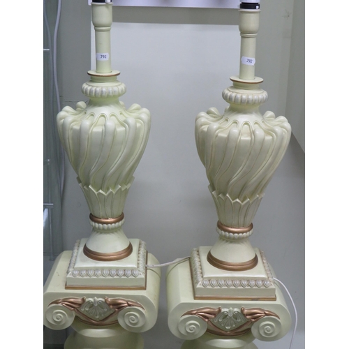 792 - Matched pair of electric lamps stood on a Greco/Romano style plinth.  Each in working order and tota... 