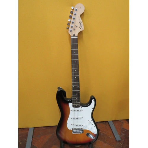 857 - Squire Stratocaster in fair condition with light superficial wear. Neck/Headstock is straight in goo... 