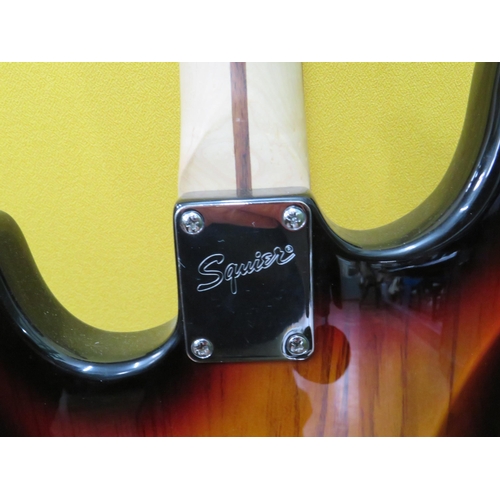 857 - Squire Stratocaster in fair condition with light superficial wear. Neck/Headstock is straight in goo... 