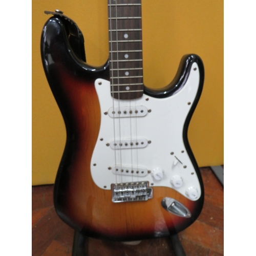 857 - Squire Stratocaster in fair condition with light superficial wear. Neck/Headstock is straight in goo... 