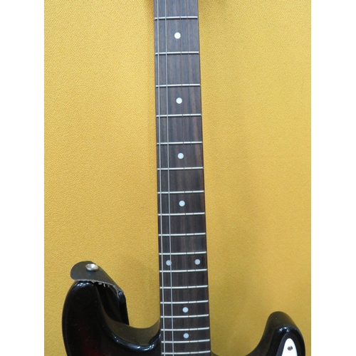 857 - Squire Stratocaster in fair condition with light superficial wear. Neck/Headstock is straight in goo... 