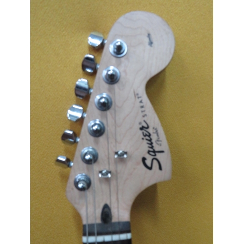 857 - Squire Stratocaster in fair condition with light superficial wear. Neck/Headstock is straight in goo... 