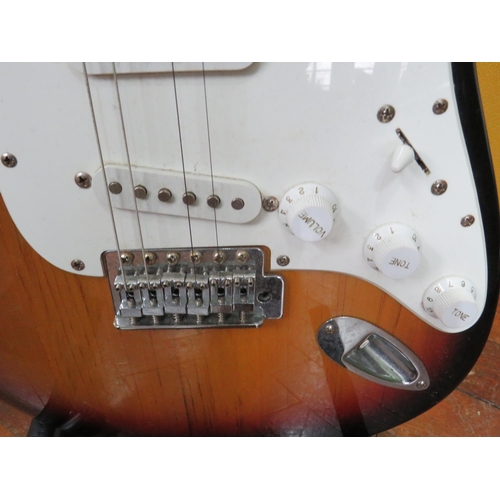 857 - Squire Stratocaster in fair condition with light superficial wear. Neck/Headstock is straight in goo... 