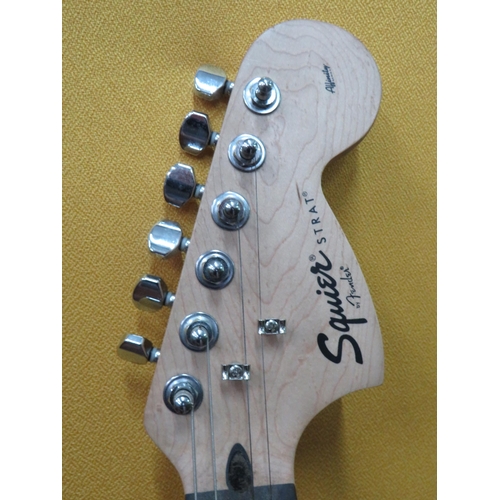 857 - Squire Stratocaster in fair condition with light superficial wear. Neck/Headstock is straight in goo... 