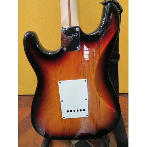 857 - Squire Stratocaster in fair condition with light superficial wear. Neck/Headstock is straight in goo... 