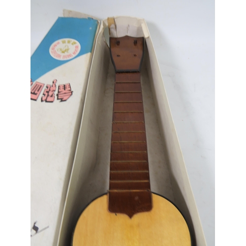 878 - Chinese ukelele with original box, no strings. See photos