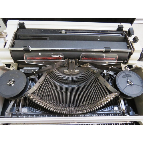 884 - Erika portable typewriter which appears to be in working order. Comes with carry case. See photos.