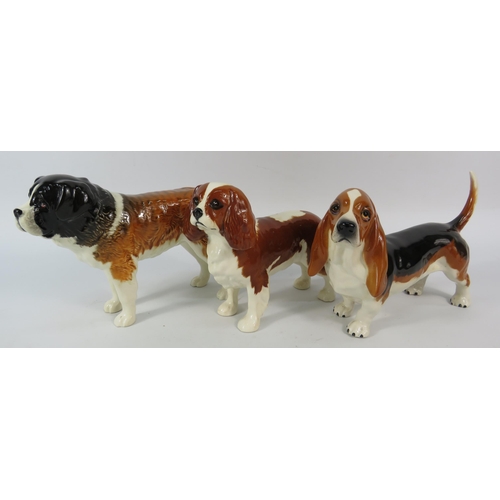 64 - Three Beswick Dog figurines, St Bernard, Cavalier King Charles and Bassett Hound, the tallest stands... 