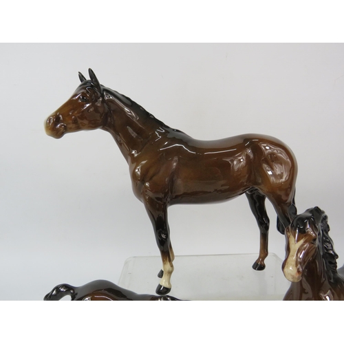 80 - Four Beswick dark bay horse figurines.