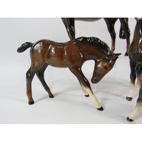 80 - Four Beswick dark bay horse figurines.