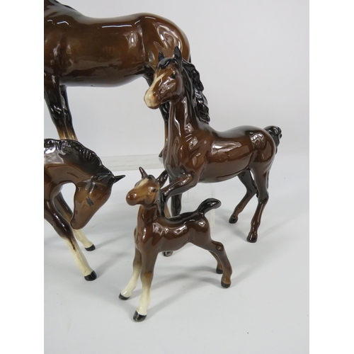 80 - Four Beswick dark bay horse figurines.