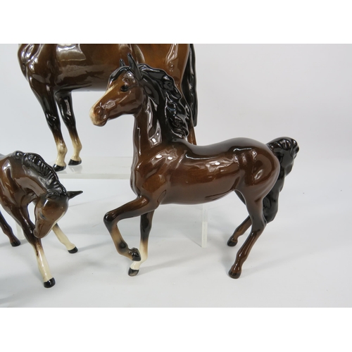 80 - Four Beswick dark bay horse figurines.