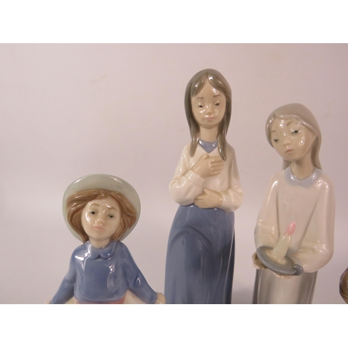 104 - Two Lladro and Two Nao figurines, the tallest stands 9