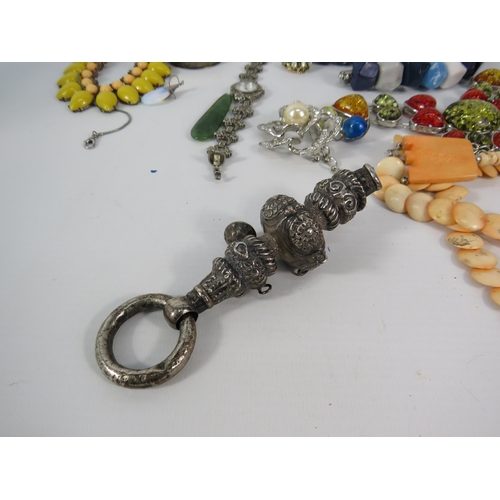 118 - A Victorian silver baby rattle and a selection of costume jewellery.