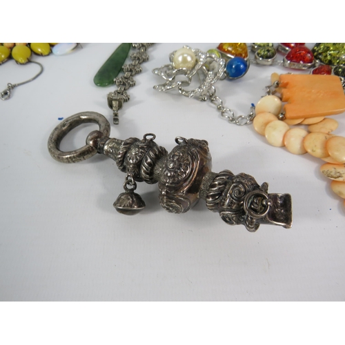 118 - A Victorian silver baby rattle and a selection of costume jewellery.