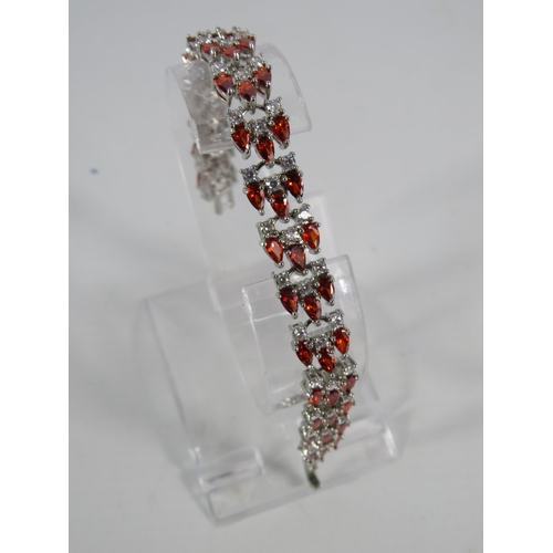 121 - 925 Sliver lab created Garnet and white topaz bracelet.