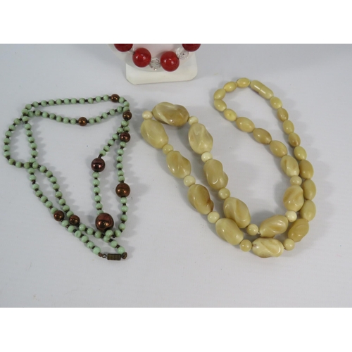 124 - Three vintage necklaces, two of which are Uranium glass.