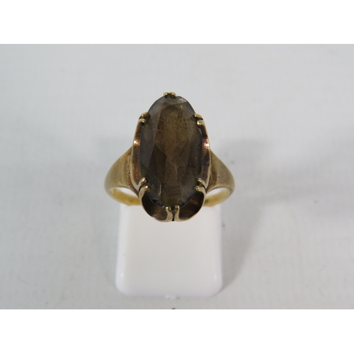 139 - 9ct Gold ring set with a 17mm by 10mm Smokey Quartz stone, finger size 